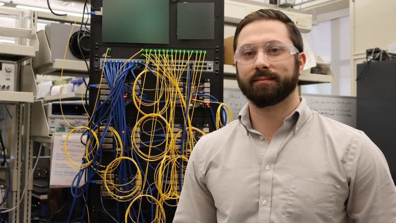 Man standing in front of board of wires